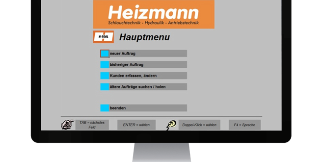 Computermonitor mit geöffneter Webseite der Firma Heizmann im Hauptmenü mit Optionen für Produkte, Dienstleistungen und Kontakte